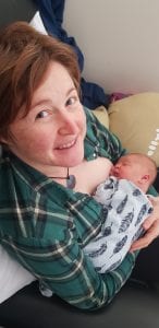 Emma holding her newborn baby