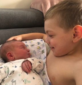 Sibling and newborn baby