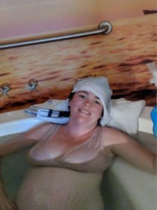 Mother in birth pool in labour