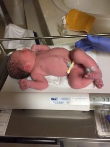 Newborn baby being weighed