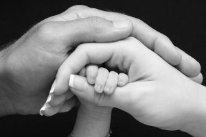 Image of mothers, fathers and babies hand