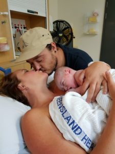 Hypnobirthing parents having a kiss right after the birth of their baby