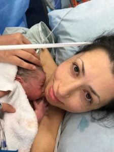 Mother Christine holds her baby after their caesarean birth