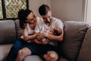 mum and dad holding baby