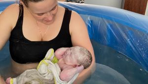 mum holding baby after water birth