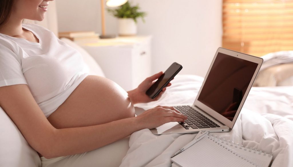 Pregnant Woman Working Bed Home Closeup Maternity Leave Pregnant woman working on bed at home