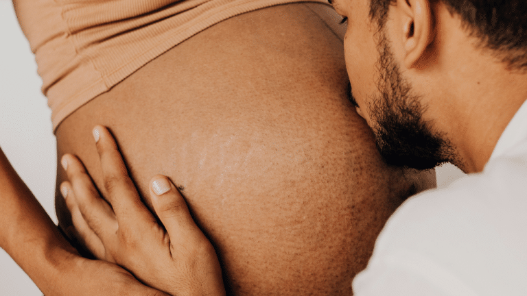 Hypnobirthing parents - Expectant father kissing pregnant mothers belly