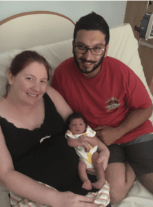 Happy mother and father with baby