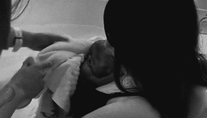 Mother with newborn after water birth